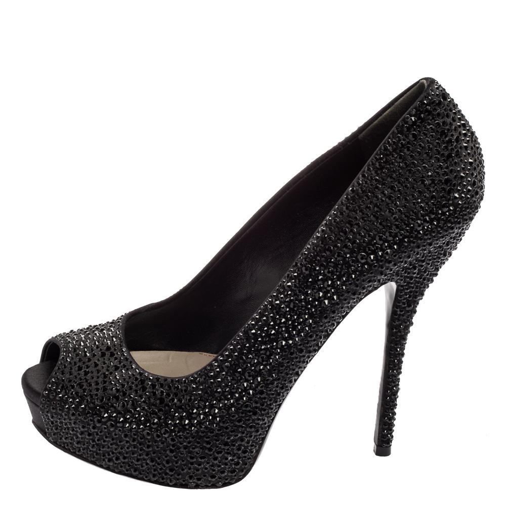 Dazzle like a diva by flaunting these satin crystal pumps from Gucci. The black pair has a peep-toe design, comfortable leather insoles, and slender 13.5 cm heels.

Includes: Original Dustbag
