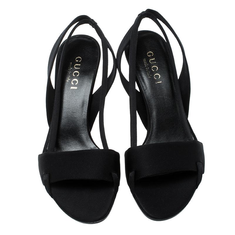 Set on a comfortable low-lying heel, this pair from Gucci features a black satin body and an open-toe silhouette. The slingback style comes with a wide frontal strap. This versatile pair can easily be styled with all your semi-formal dresses and