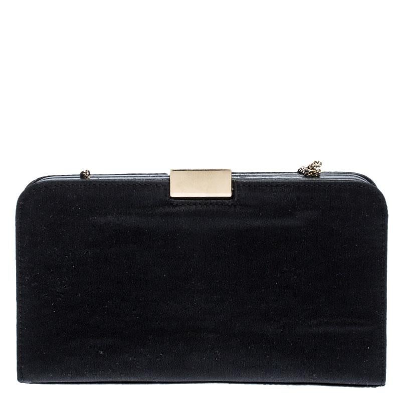 This stunning clutch by Gucci is a closet staple. It is crafted from luxurious satin and comes in a classic shade of black. It has a structured silhouette and features a gold-tone push-lock closure with the brand's logo that opens to reveal a