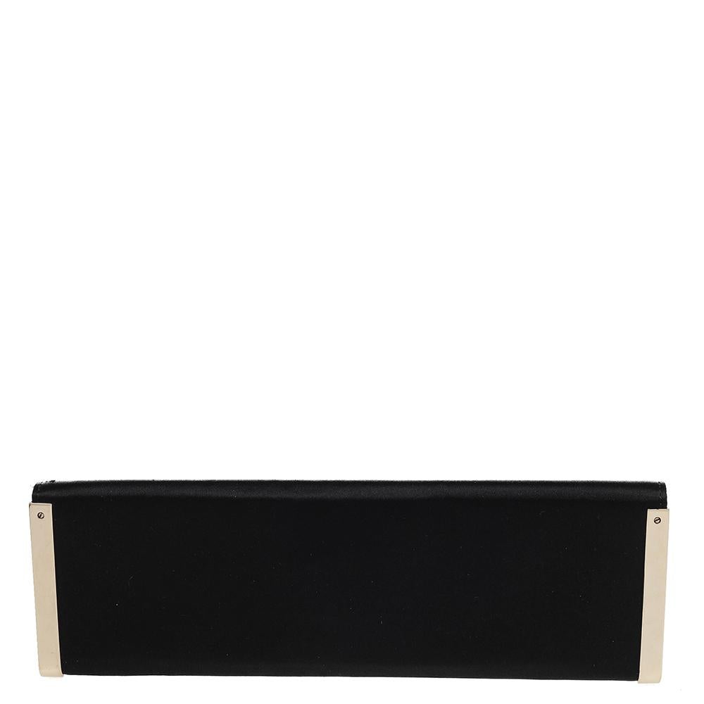 This clutch from Gucci is designed in black satin. It brings gold-tone metal on the sides, the logo at the front, and a lined interior. The elongated style of the clutch makes it easy to carry.

Includes: Original Dustbag