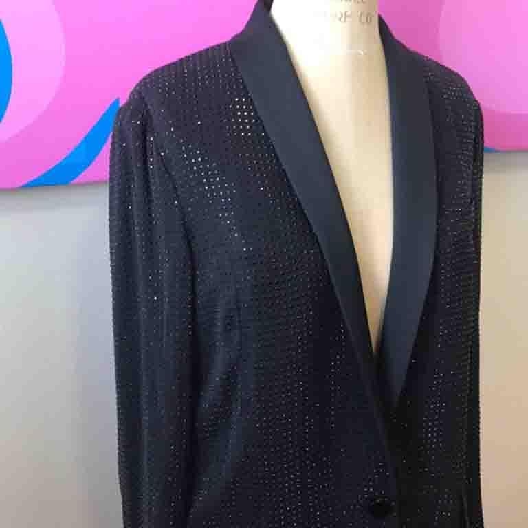Unique black evening jacket by Gucci has tuxedo vibes and tons of tiny beads! Shine like the star you are wearing this!
Perfect with black silk pants or a pencil skirt.

Size 40
Across chest - 19 1/2 in.
Across waist - 17 in.
Shoulder to hem - 29