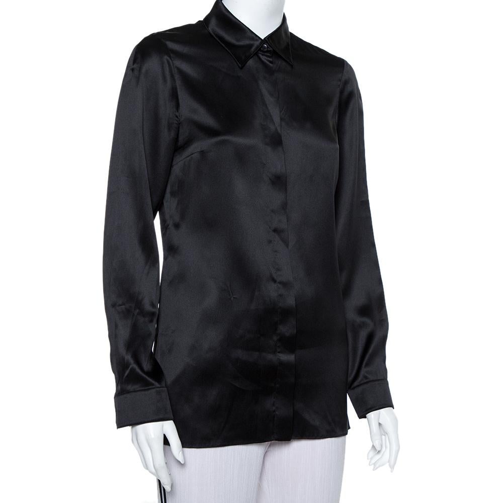 The classic black shirt from no other label but Gucci. It is tailored using silk into a simple formal shirt and finished with a well-cut buttoned collar, long sleeves, and full front buttons. The well-made shirt offers a great fit.

