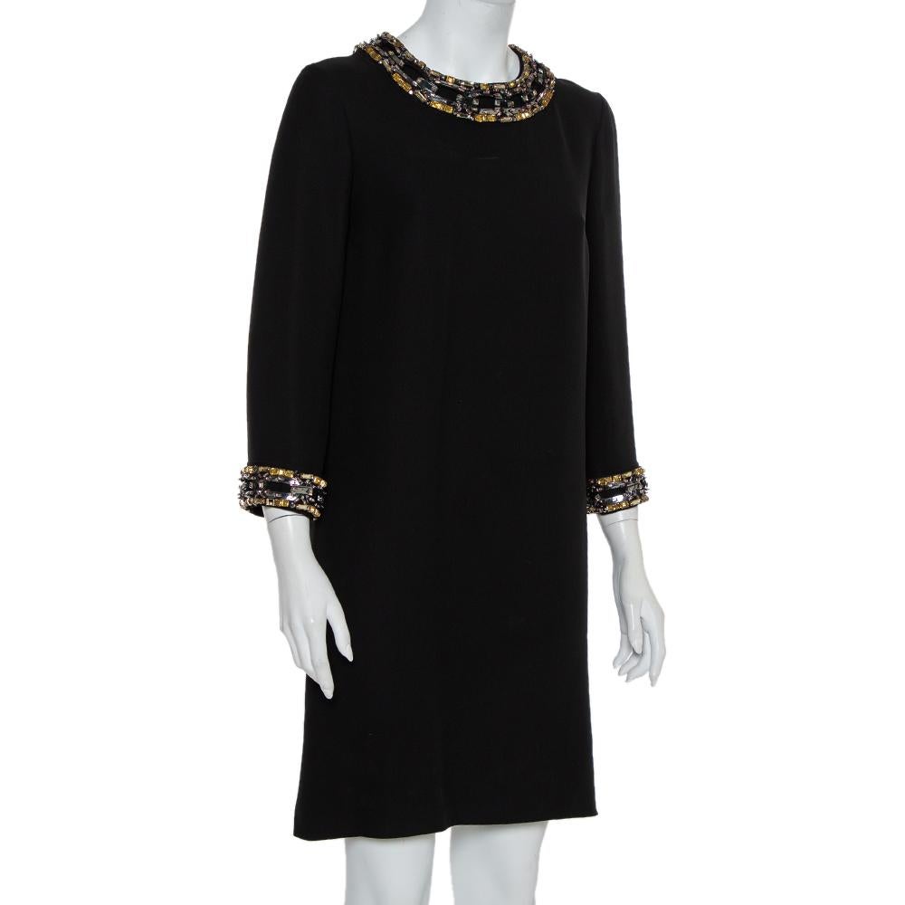 This shift dress is from Gucci's Pre-Fall 2014 collection. Tailored in silk, the black dress has a simple silhouette but it is highlighted with stunning embellishments on the long sleeves and round neckline. It is secured by a back zipper.


