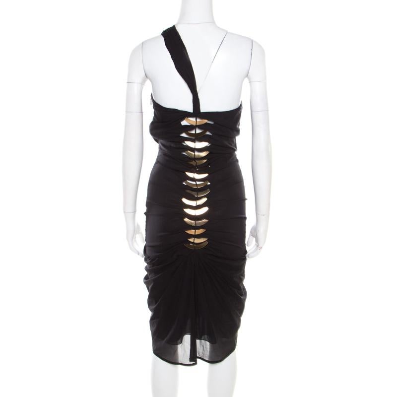 This chic dress from the house of Gucci features a ravishing design making it a must-have piece in your closet. Finely tailored in blended silk, this dress has metal fishbone-like embellishments. This black dress can be made more glamorous by adding