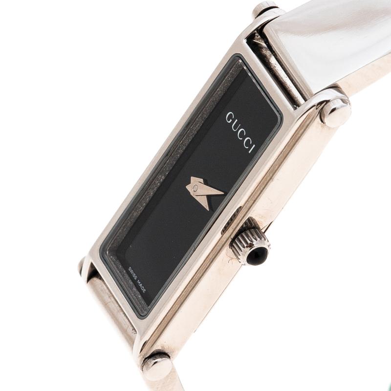 Coming from the house of Gucci, this 1500L wristwatch is designed in a stainless steel body with a case diameter of 12mm. It comes fitted with a sleek rectangular black dial detailed with silver-tone hands. Powered by quartz movement, this watch