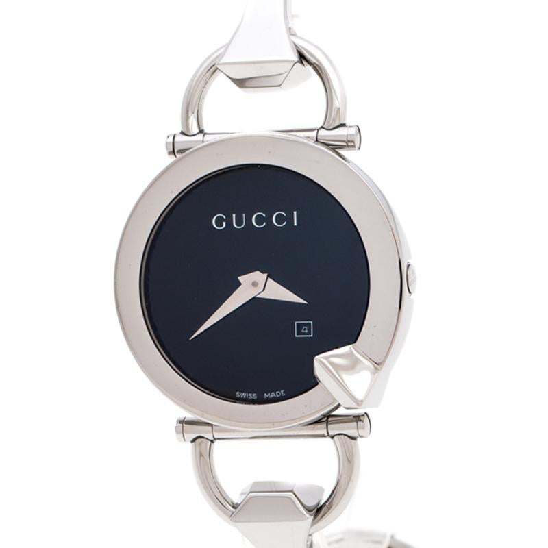 This classy Gucci watch combines beauty and femininity. Its round case features a well-designed bezel. The black dial is combined with silver-tone hands and its minimalist style is taken further with a petite date window. The link bracelet is made