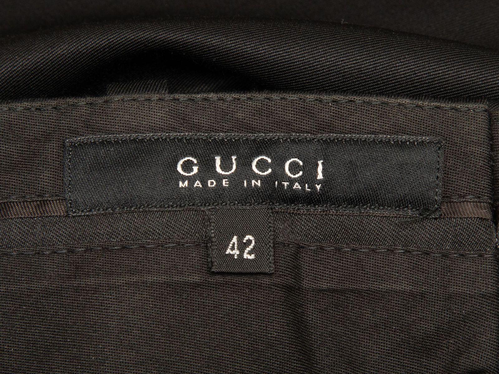 Product Details: Black silk straight-leg trousers by Gucci. Dual front welt pockets. Front zip closure. Designer size 42. 28