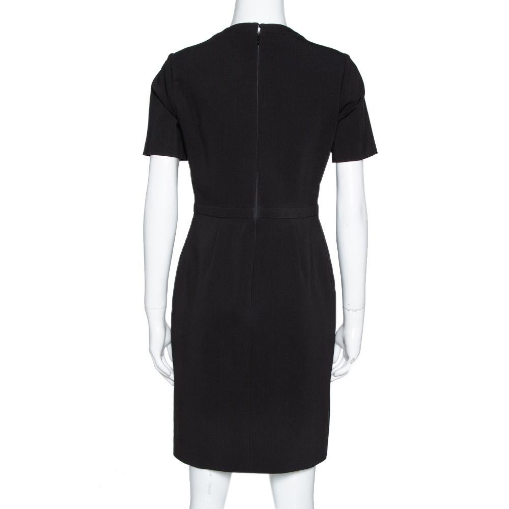 Style this black dress with the right accessories for an impeccably fashionable look. Beautifully tailored to offer you the best fit, this Gucci dress has short sleeves, a nipped-in waist, buckle details on the front and a back zipper.

