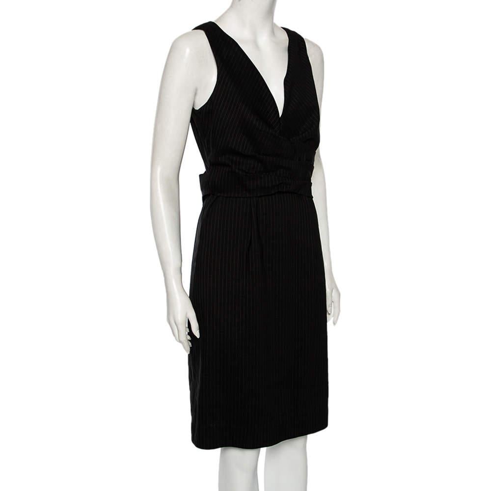 This black sleeveless dress is from Gucci's collection of effortless clothing. Tailored into a simple, comfortable silhouette, the dress is complemented by a V neckline and a matching belt.

