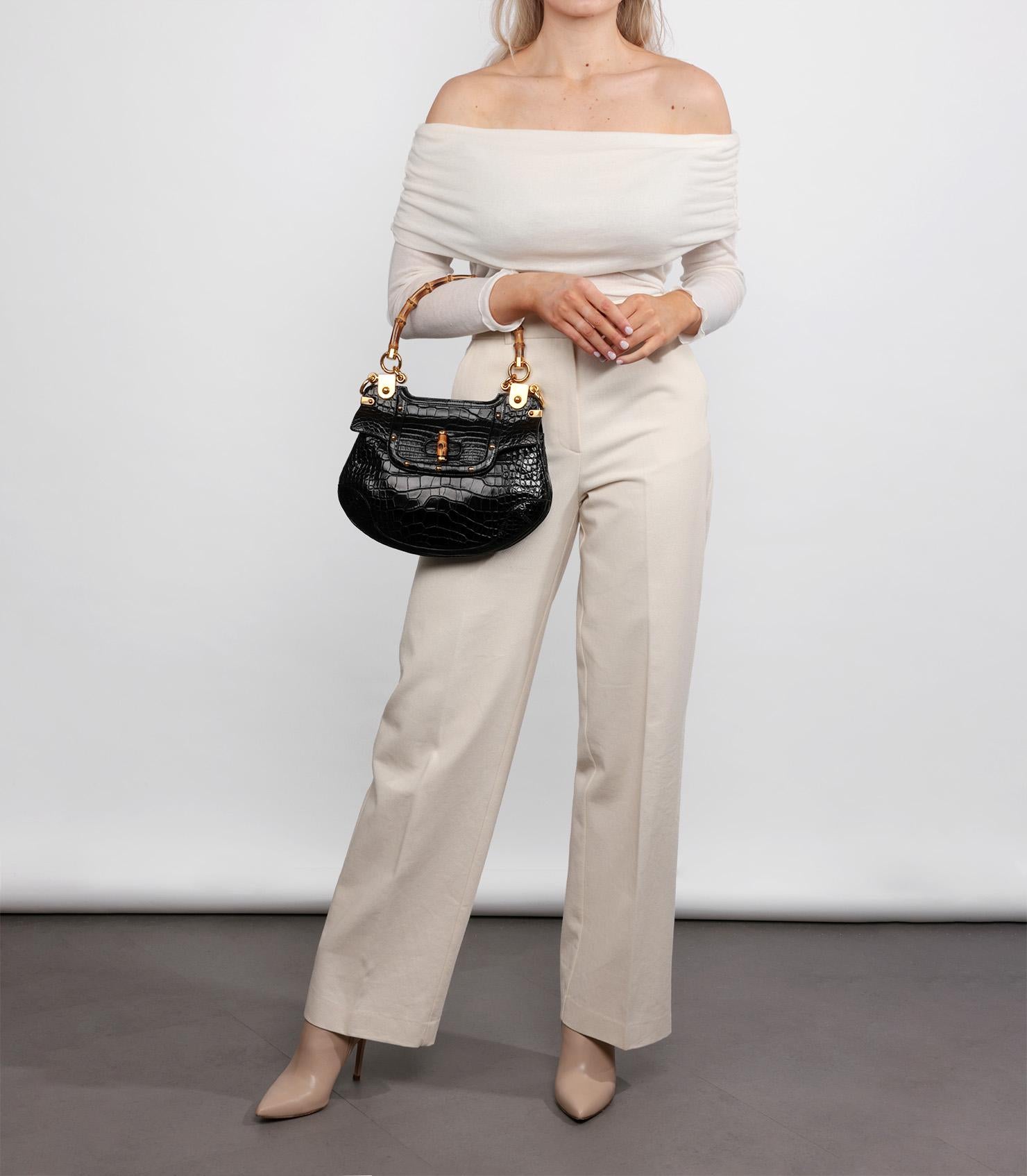Gucci- Black Studded Shiny Alligator Leather Vintage Bamboo Top Handle

Brand: Gucci
Model: Bamboo Top Handle Shoulder Bag
Product Type: Shoulder, Top Handle
Serial Number: 15***********
Accompanied By: Gucci Dust Bag
Colour: Black
Hardware: