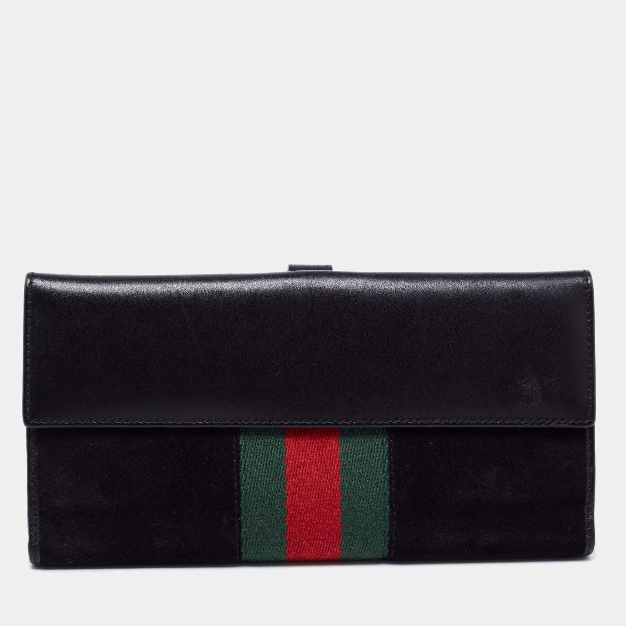 Infused with signature elements, this Gucci wallet is an accessory of utility. It is crafted from suede and canvas with a branded black-tone lock on the front and a Web stripe on both sides. The leather interior is divided into different