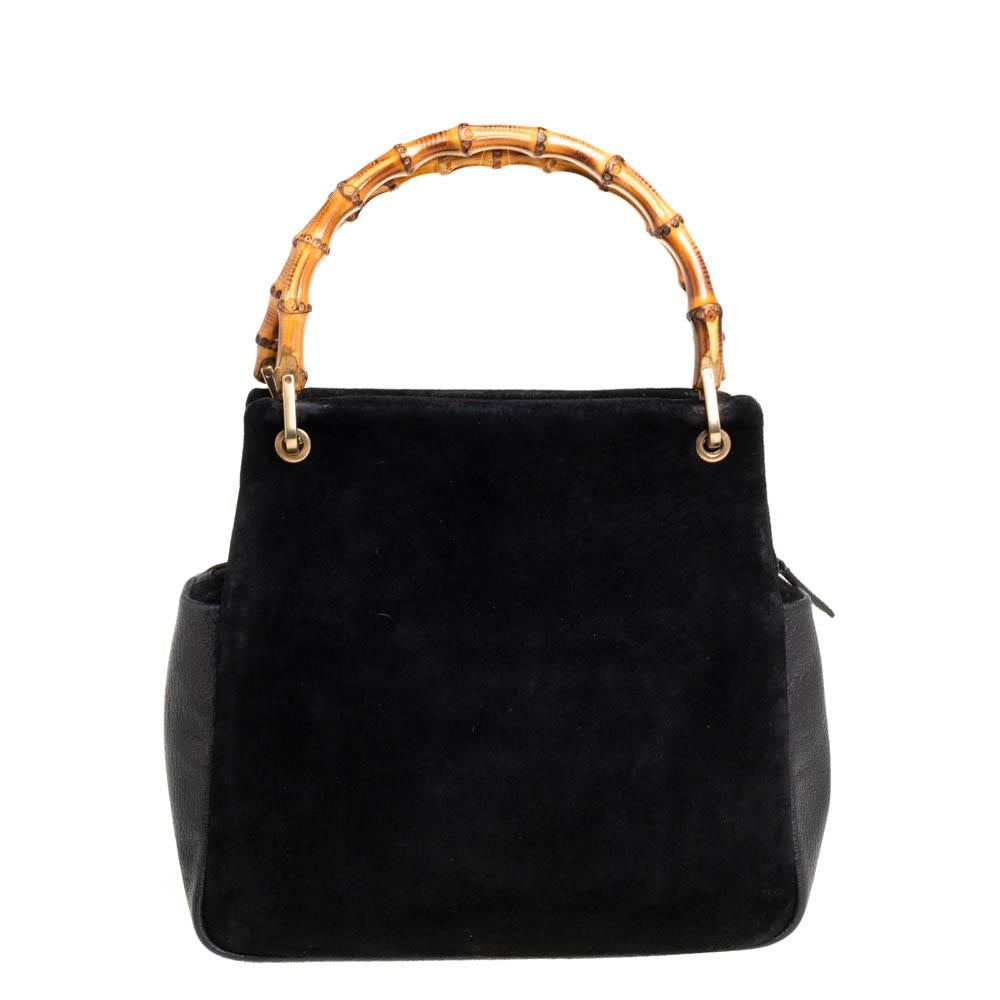 Handbags as fabulous as this one are hard to come by. So, own this gorgeous Gucci tote today and light up your closet! Crafted from suede and leather in a classic black hue, this stunning number has a spacious canvas interior and is wonderfully held