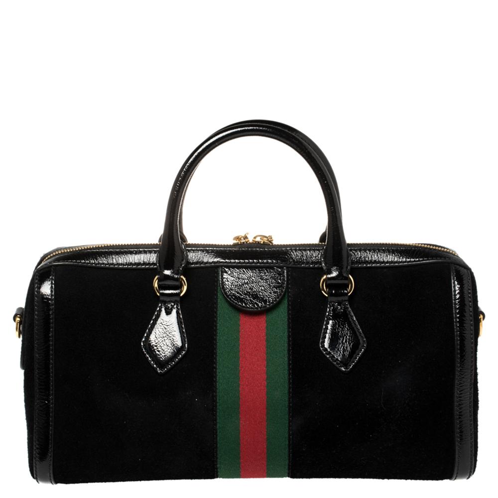 Add to your look by accessorizing with this Gucci Ophidia satchel. Designed expertly, this bag features a suede & patent leather body that is striking. The bag flaunts the signature Web stripe and GG logo on the front and two top handles. It is