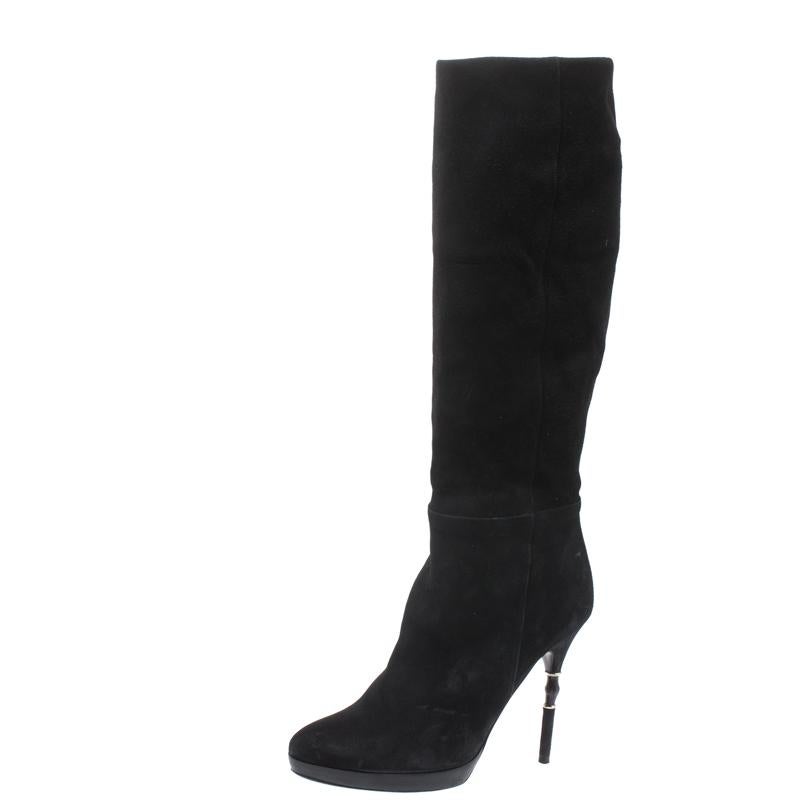 Simple and sophisticated, these knee-high boots from Gucci are a must-buy for the fashionable you. These black boots are crafted in suede and come balanced on bamboo-detailed heels. They can be paired with a long tunic or an oversized shirt to make