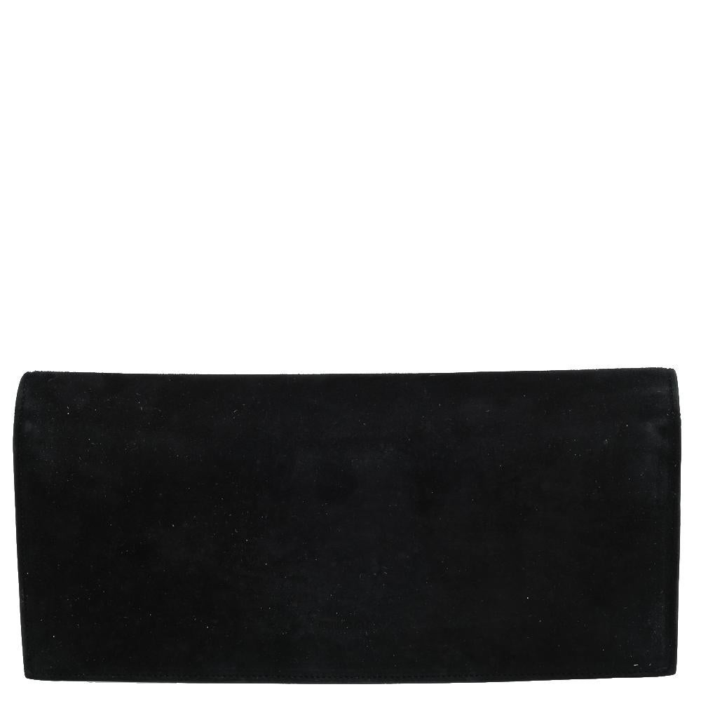 This Gucci clutch will give a beautiful touch to your evening ensemble. Crafted from suede in Italy, the clutch is designed with crystal detailing on the flap that reveals a leather interior. The breathtaking black hue that covers its expanse just