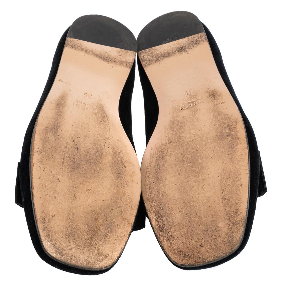 Add the right slant of style with these Gucci smoking slippers. The black suede slippers feature Gucci's bee motif and pearls over the toes and leather insoles for a comfortable fit.

