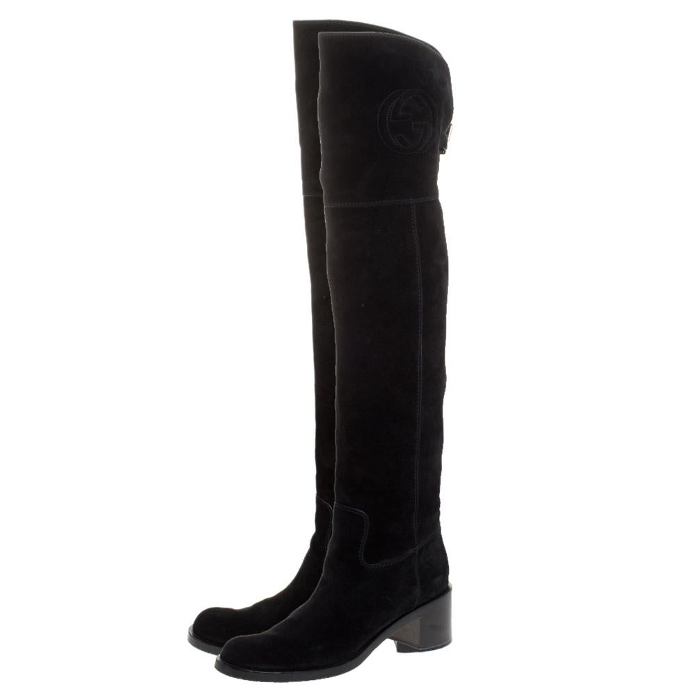 Your winter wardrobe would take an all-new shape by adding these stunning knee-length boots by Gucci. These are classic suede boots featuring a black shade coupled with GG logo on the top and buckled straps at the rear. Adding to the functionality