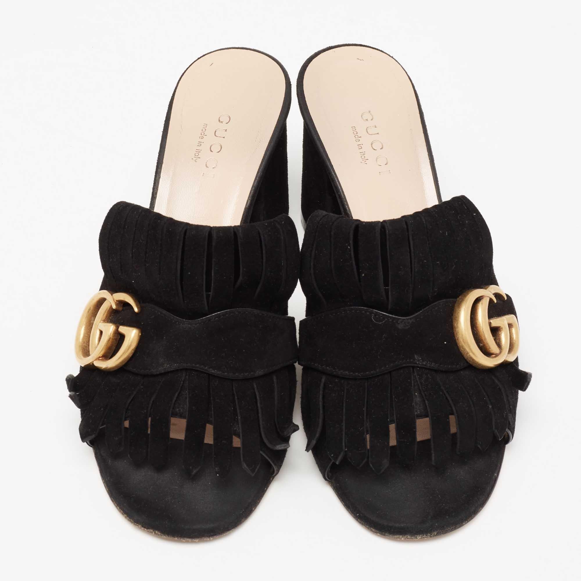 Gucci presents us with an impeccable creation that will make your style stand out. These GG Marmont mules from Gucci are crafted using suede with fringed detailing and a gold-toned GG motif attached to the vamps. They are completed with open-toes