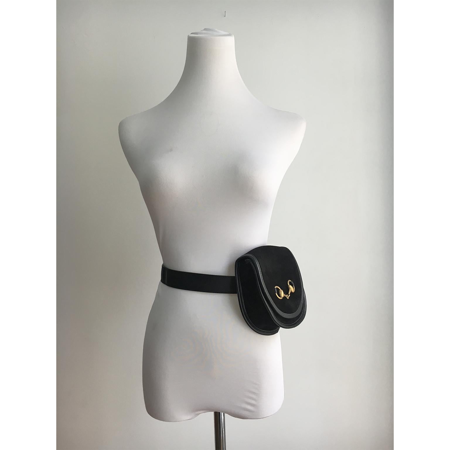Vintage Gucci black suede golden Horsebit belt bag Coin Pouch from circa 1980s. Matte gold tone horsebit and magnetic clasp closure with gucci logo embossed.  Exterior is in excellent condition. Originally the interior was made out of plastic
