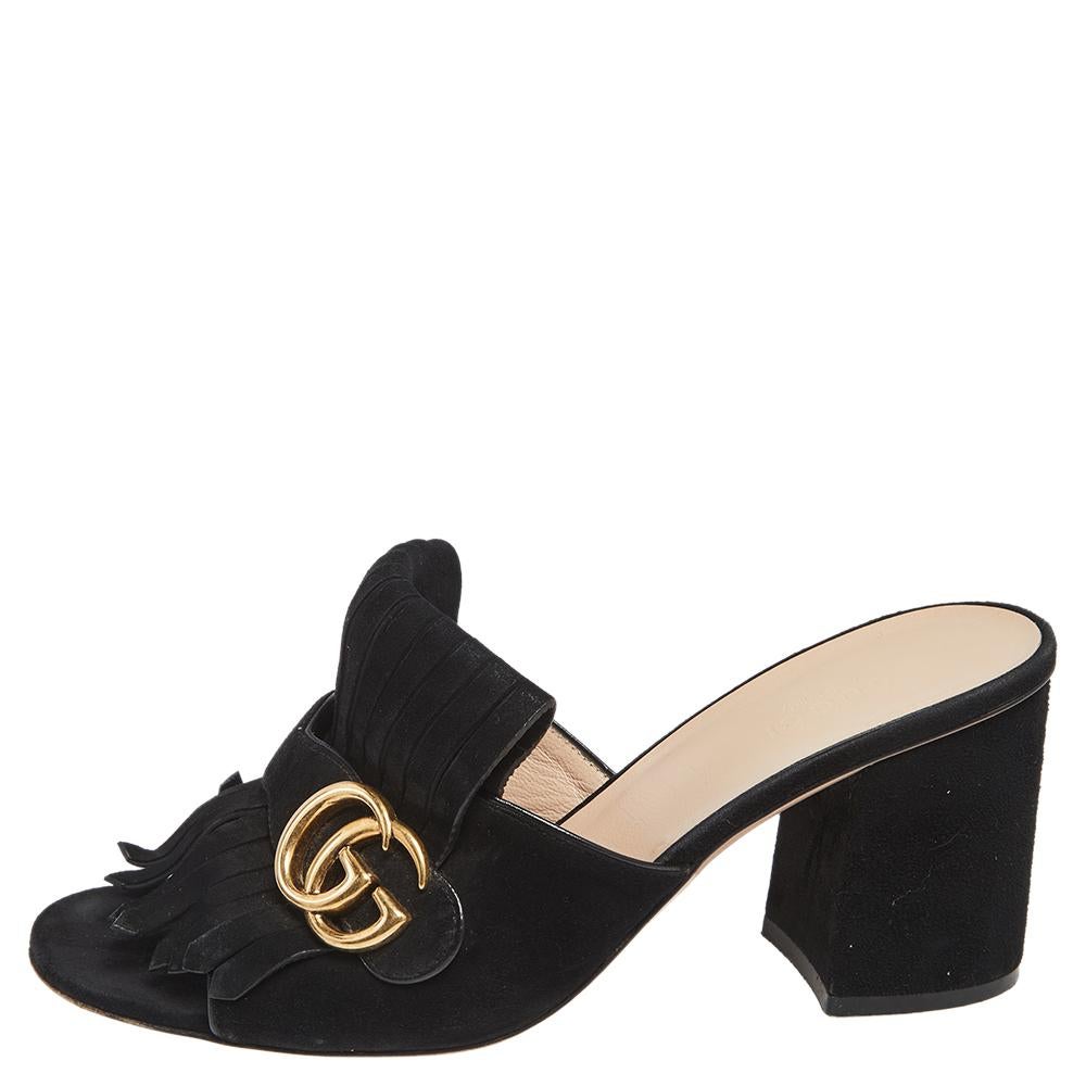 One of the iconic and instantly recognizable designs from the house of Gucci, these GG Marmont mules are here to stay. Crafted in soft suede, these mules feature covered block heels for comfort along with folded fringed details over the vamps and a