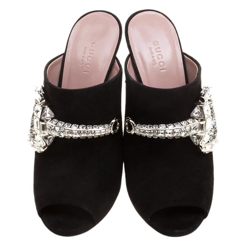 Add an instant touch of shine and glam to your look for those special events by pairing these Gucci Maxime mules with your outfit. The black suede body of these shoes is further made special with the use of crystal embellishment in the signature
