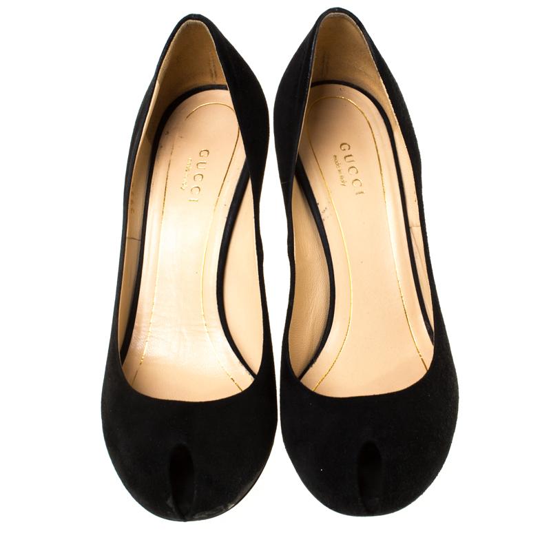 These classic Gucci pumps make for an ideal formal and informal adornment. Crafted in black suede, the pumps feature leather insoles, gold-tone heels and peep toes. Pair these lovely pumps with your favorite outfit for a high style!

Includes: The