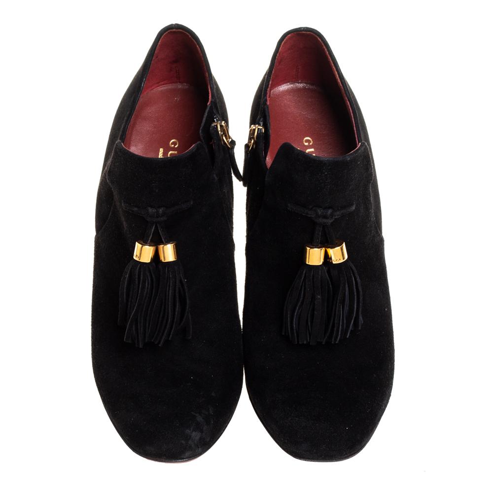 We've fallen in love with these gorgeous black Gucci booties! These booties are crafted from suede and feature almond toes. They've been styled with tassels, side zippers, and 11 cm heels to lift you while walking. Pair them with a jacket and