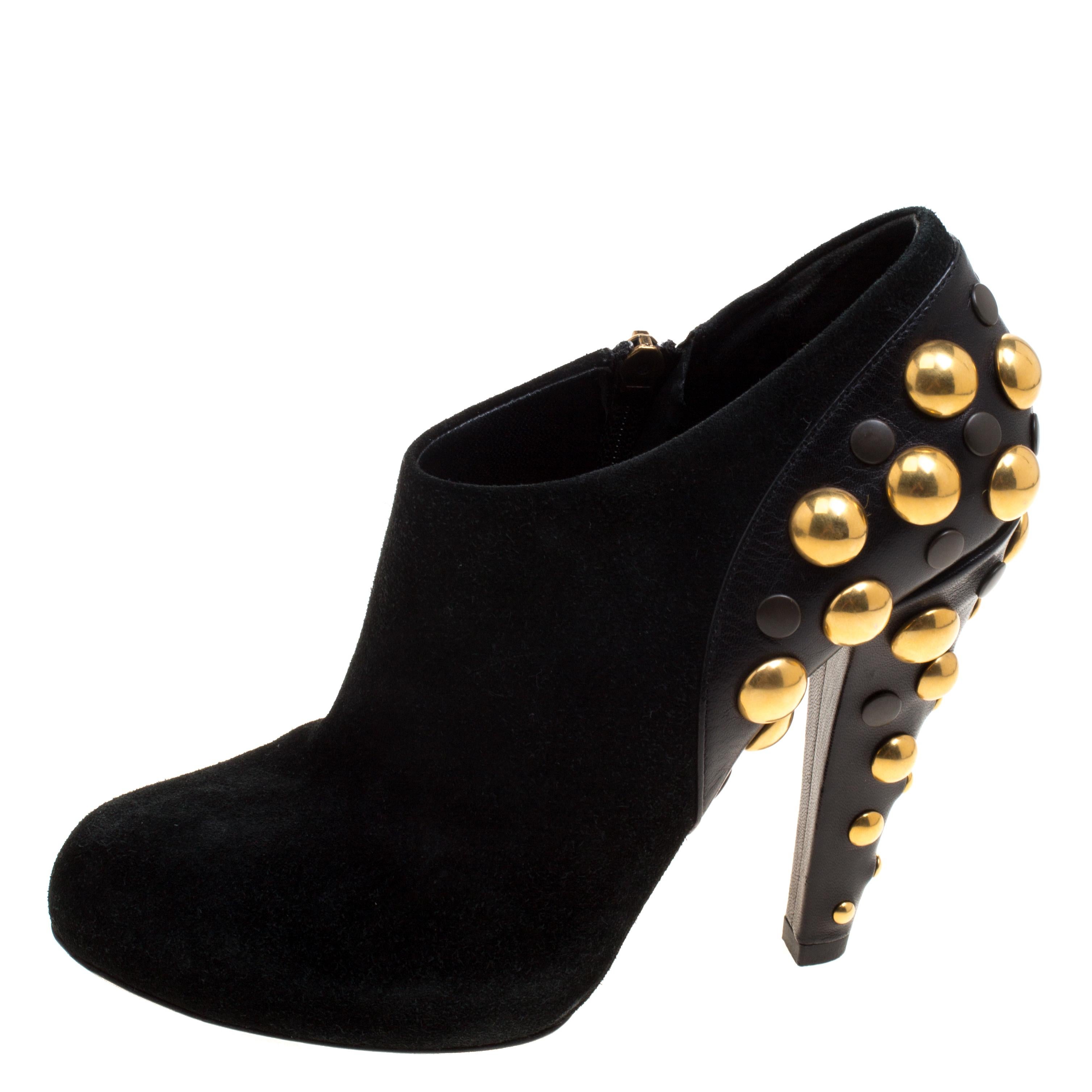 Boots that stand out and speak for themselves, these Gucci ankle boots will never fail to make a stylish statement. Constructed in black suede, this Vintage Babouska piece features a black and gold studded back all the way down the heels that will