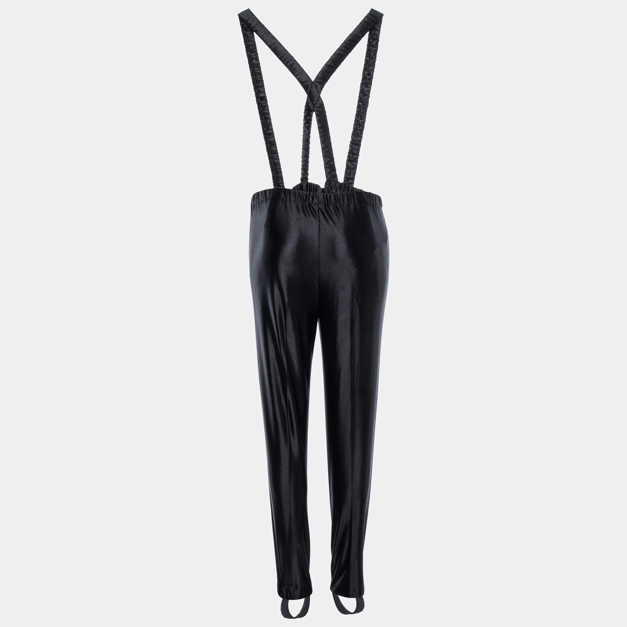 The Gucci pants are a fashion statement. Crafted from high-quality synthetic materials, they feature a classic black color and attached suspenders for a trendy twist. These pants offer a blend of style and sophistication, perfect for those seeking a