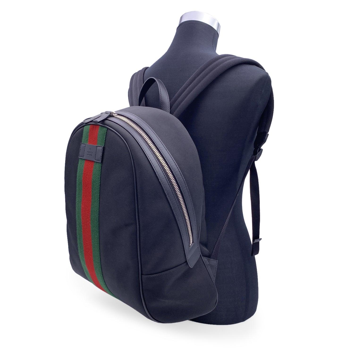 Unisex Backpack by Gucci, crafted in durable black techno canvas. It featuresgreen/red/green stripes on th front. Upper zipper closure. 1 side zipper pocket inside. Adjustable backstraps. 'GUCCI - Made in Italy' tag (with serial number on its