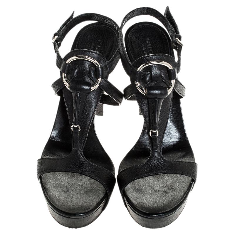 Get these stunning sandals by Gucci and instantly elevate your outfits. Crafted from textured leather, they come in a classic shade of black. They have an open toe silhouette, t-straps with the signature Horsebit detailing, buckled ankle straps,