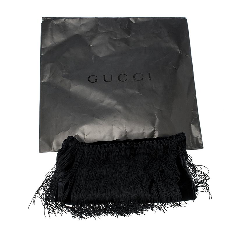 This season is all about tassels and fringes. Embrace the season's trend with this chic scarf from the house of Gucci. Featuring a black velvet body, this scarf features satin web-detailed 'GG' print on it and completed with tassels along the edges.