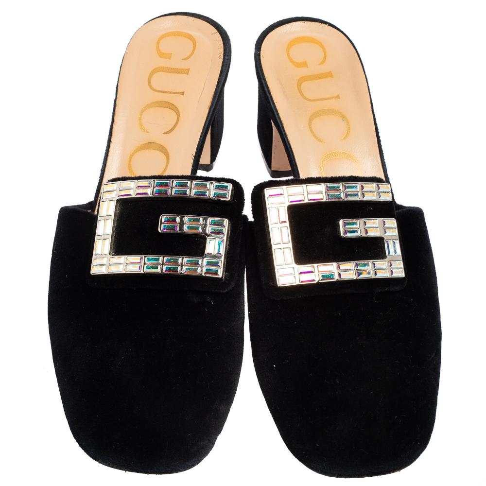 Gucci's timeless aesthetic and stellar craftsmanship in shoemaking is evident in these stunning mules. Crafted from velvet, the silhouette is adorned with an embellished G motif on the uppers then raised on low block heels. Style them with flared