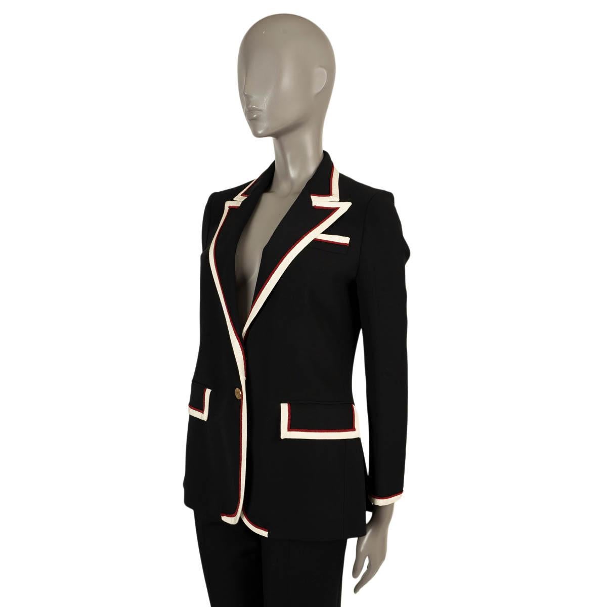 100% authentic Gucci stretch cady blazer in black viscose (with 3% elastane). Features white and red grosgrain trim, peak lapels, buttoned cuffs and two flap pockets. Closes with two gold-tone buttons on the front and is lined in printed silk