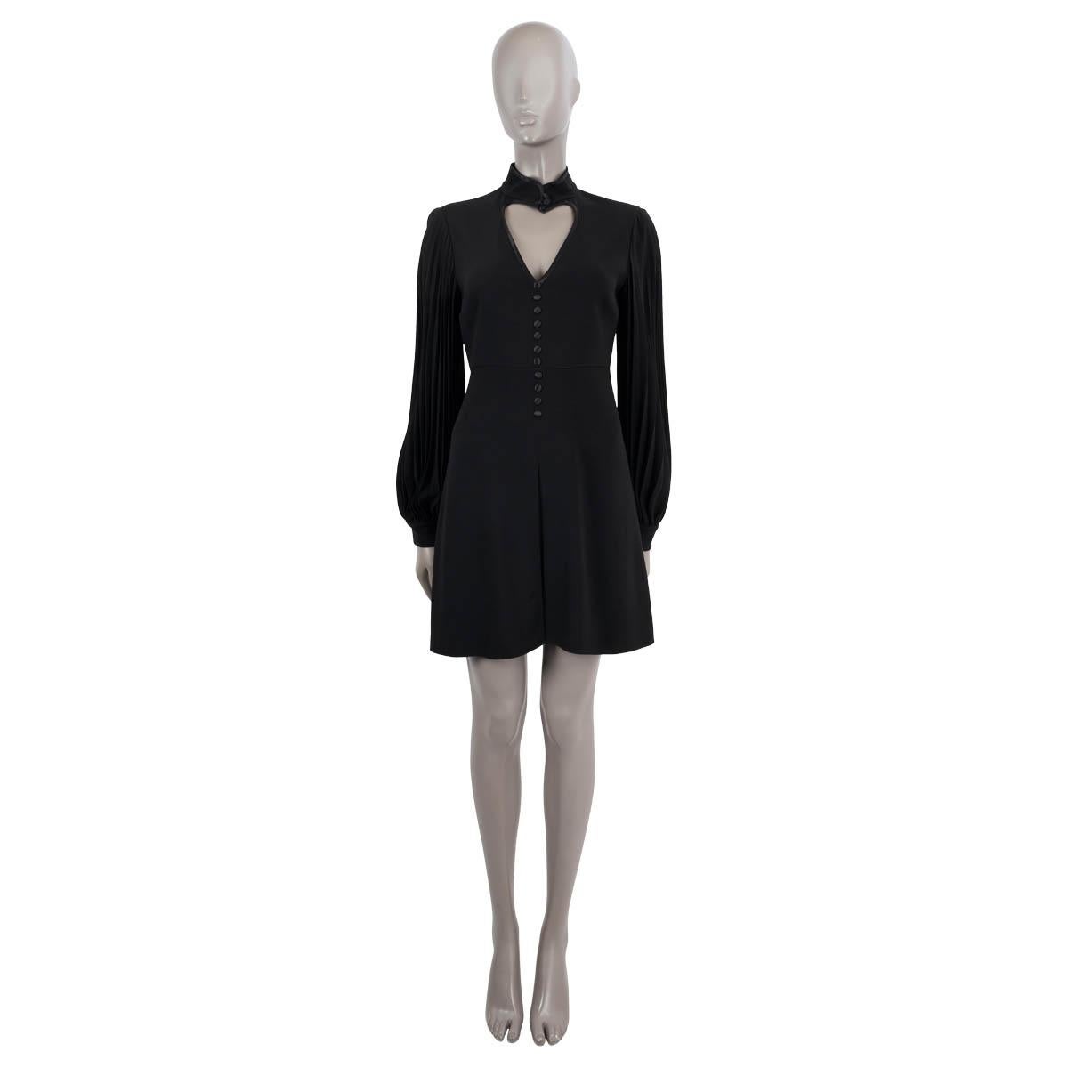 100% authentic Gucci jersey dress in black viscose (70%), acetate (27%), elastane (3%). Features a heart cut-out on the front, brand collar, billowing pleated sleeves and decorative silk covered buttons on the front. Closes with a zipper in the