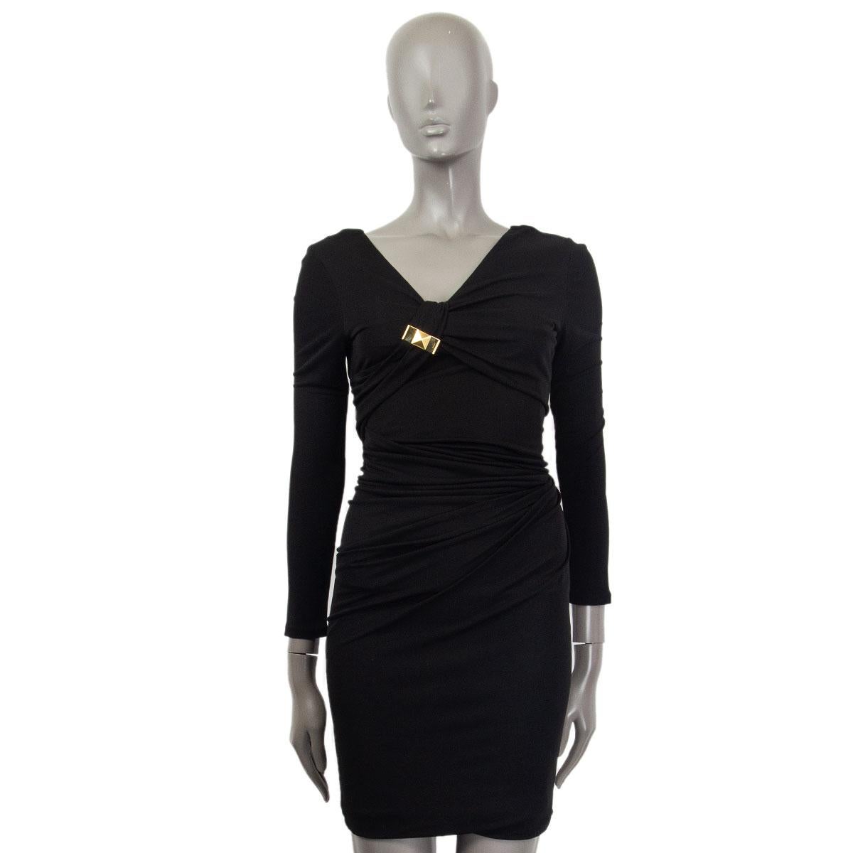 100% authentic Gucci sleeveless draped bodycon dress in black viscose (100%) with a lining in acetate (65%) and nylon (35%) with a gold-tone metal pyramid detail at front. Opens with a zipper on the back. Has been worn and is in excellent condition.