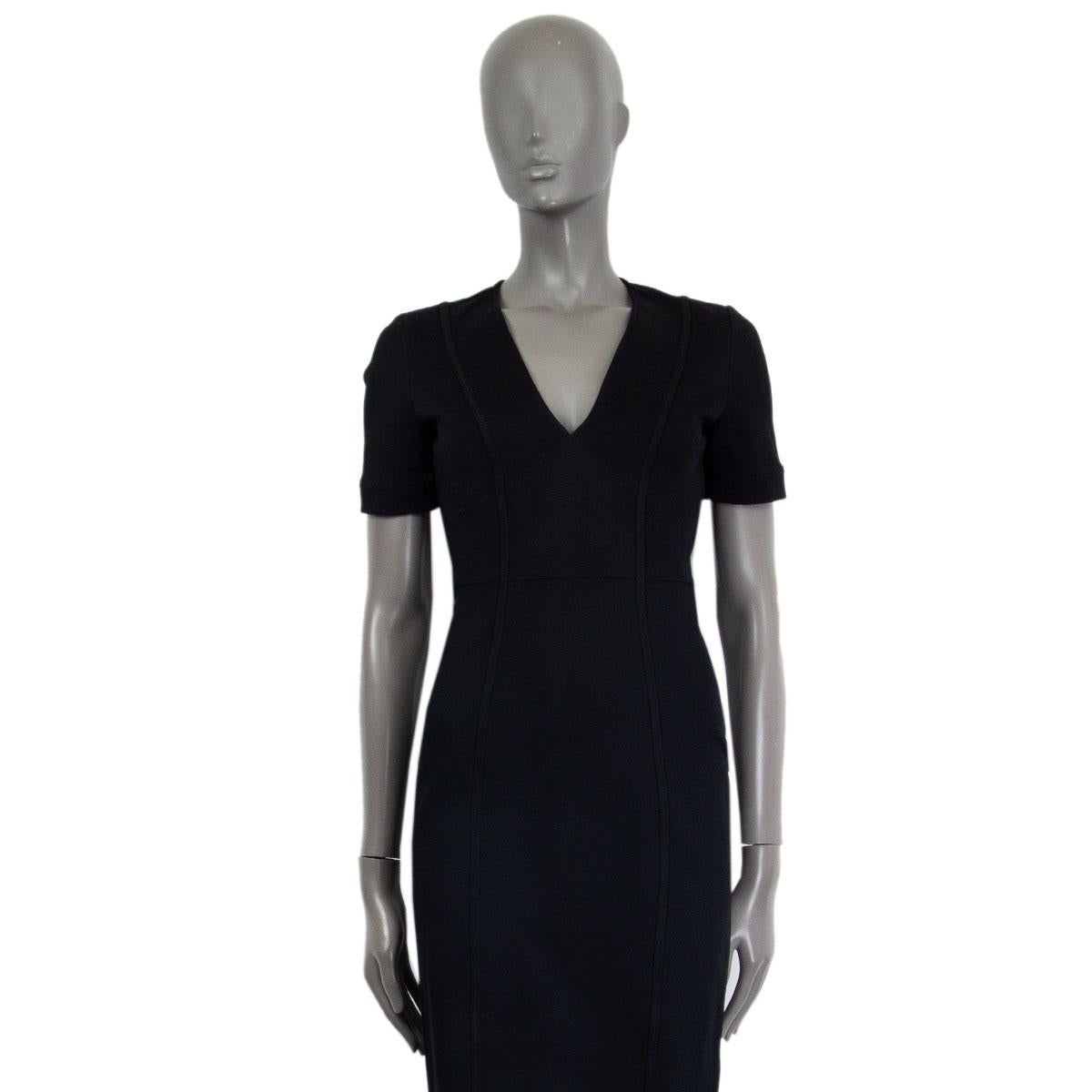 100% authentic Gucci short sleeve bodycon dress in black viscose (80%), polyamide (14%) and elastane (6%) with a deep v-neck. Closes on the back with a concealed zipper. Unlined. Missing a belt. Has been worn and is in excellent