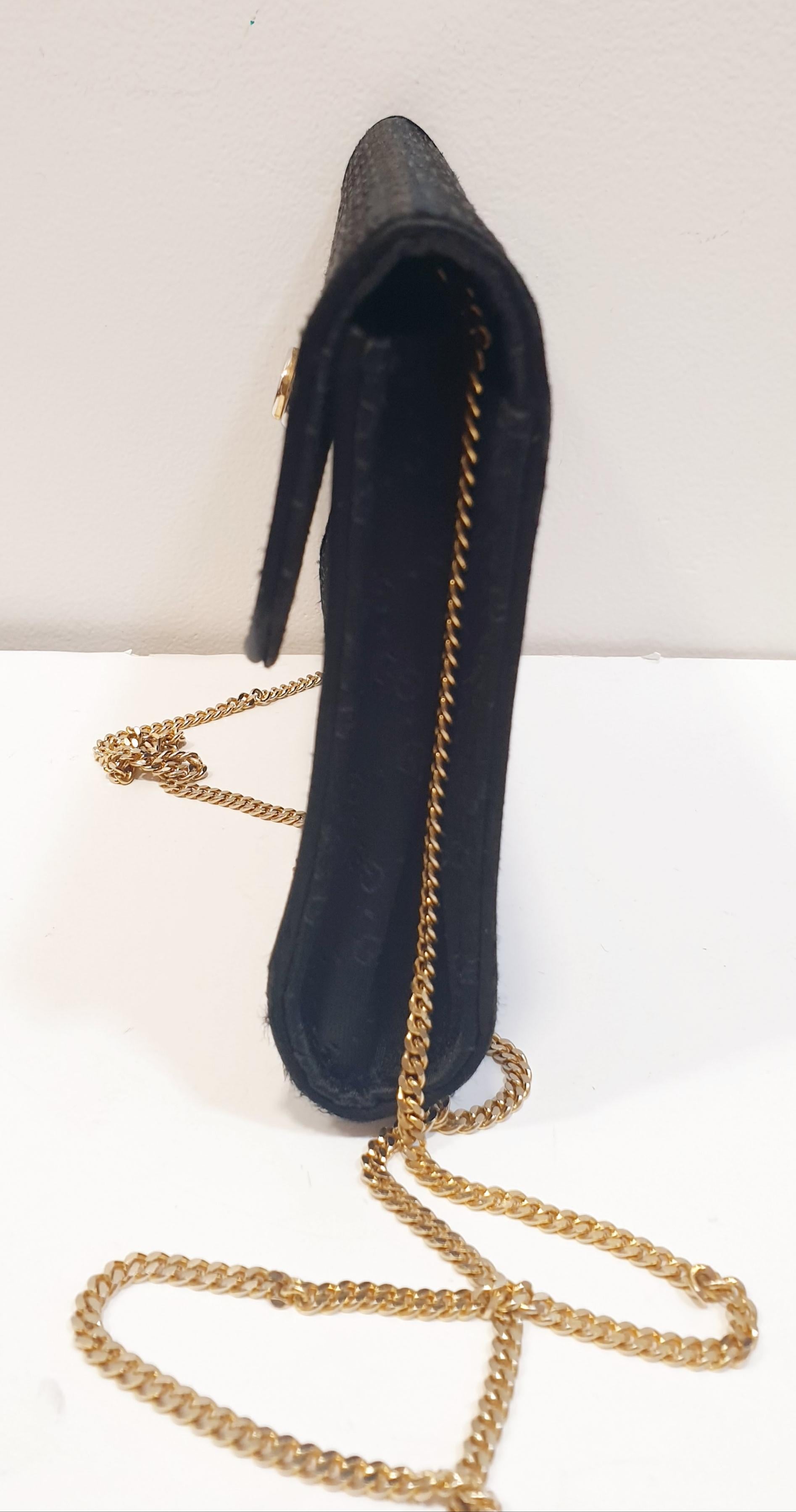 black gucci clutch with gold chain