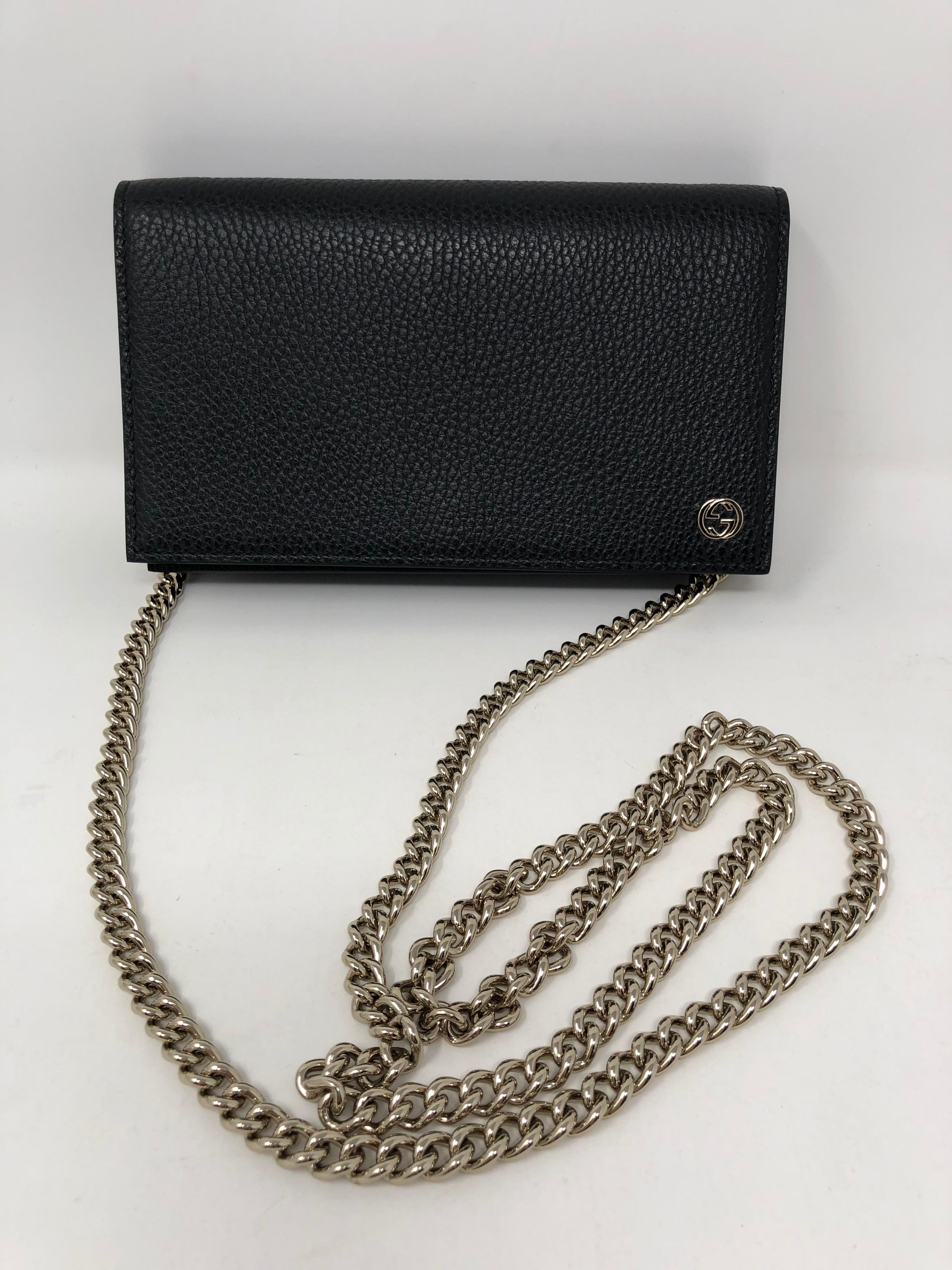 Gucci Black Leather Crossbody Bag. Wallet on a chain style with gold hardware. Like new condition in box. Guaranteed authentic. 