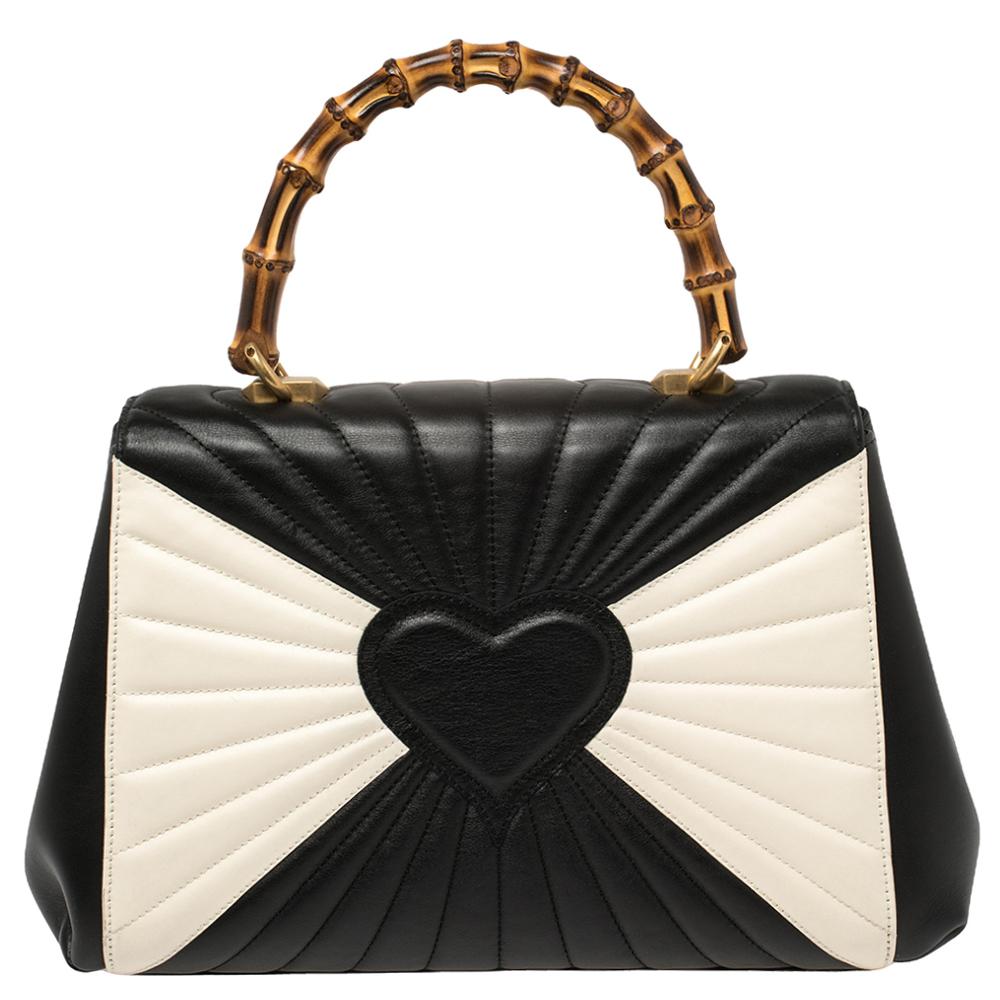 This beauty is from Gucci's 2017 collection and it is a sight to behold! It is excellently crafted from leather and designed to make every handbag lover swoon. The bag holds a sunrise-like quilt all over, black & white color-block detailing, and an