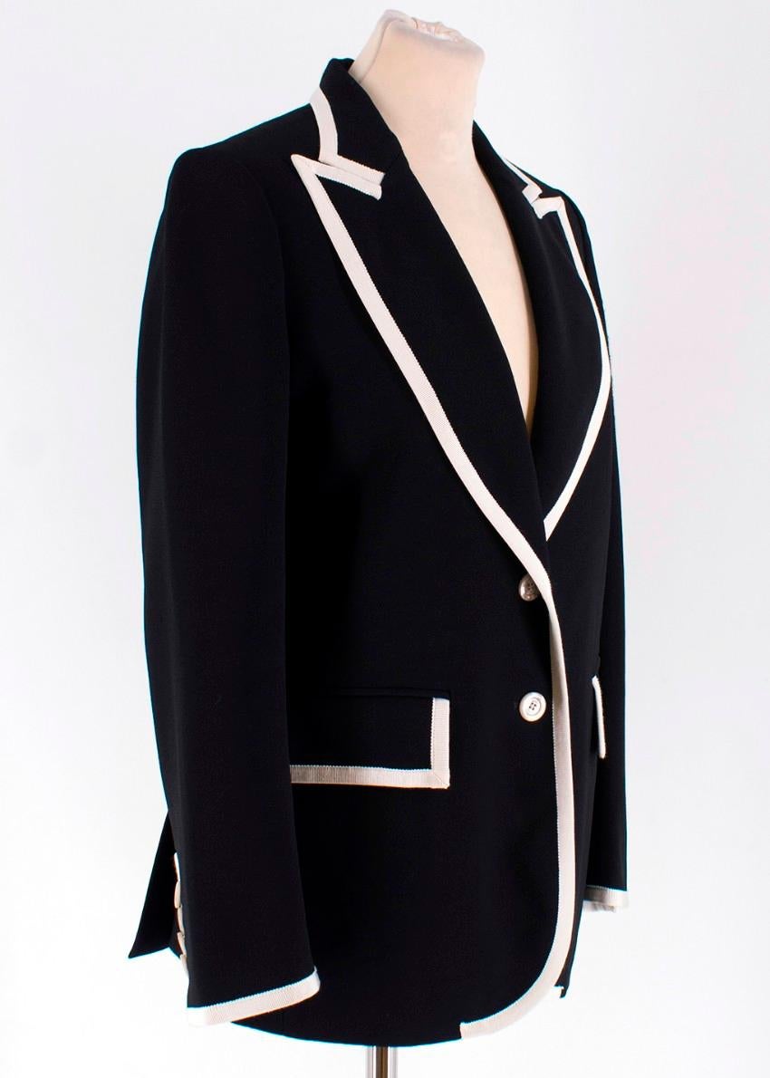 Gucci Peak Lapel Stretch Cady Blazer

-Black blazer with contrast white trim
-Peak Lapels
-Two front pockets
-Floral lining
-Two button closure
-Buttons on cuffs
-Double vent at the back

Please note, these items are pre-owned and may show signs of