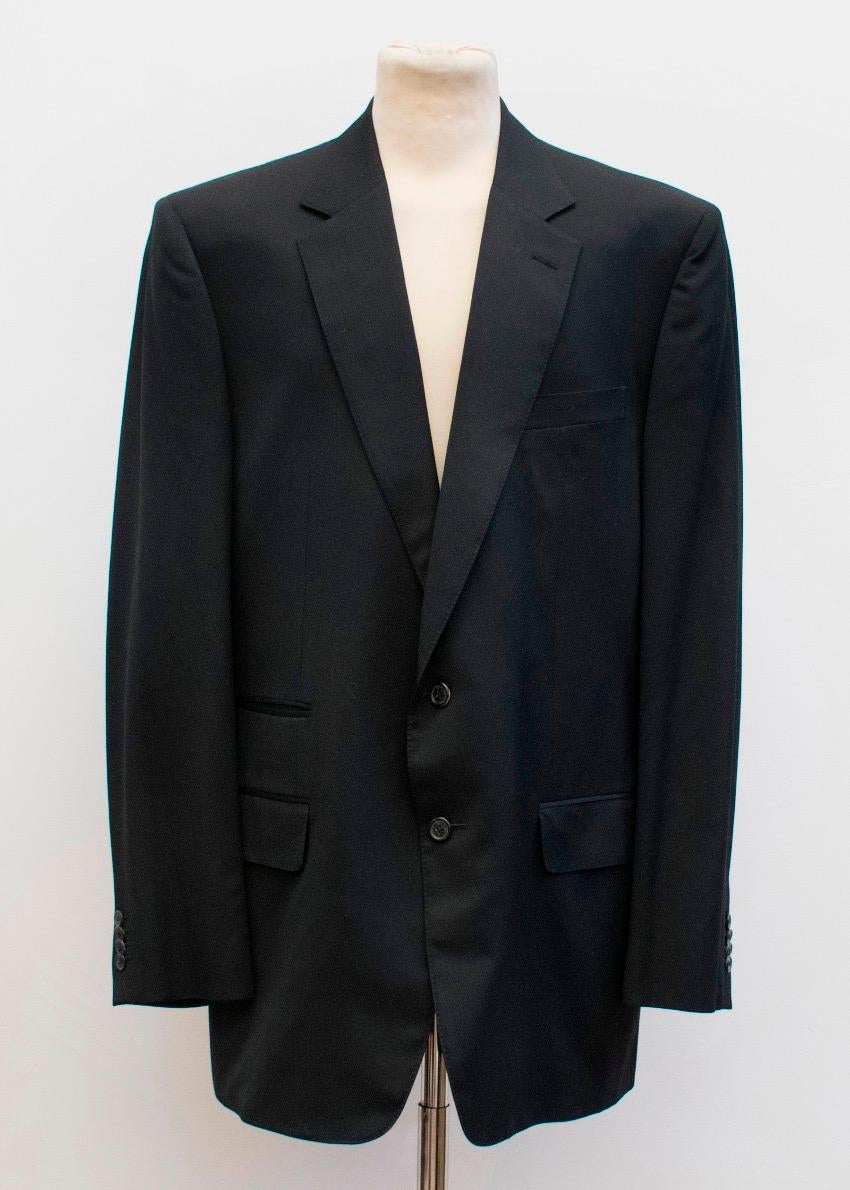 Gucci black wool suit. The jacket features notch lapels, shoulder padding, three front pockets, two inside pockets, Gucci monogram print on inner lining, four button cuffs and two button closure.

The trousers feature belt loops, front pleat, two