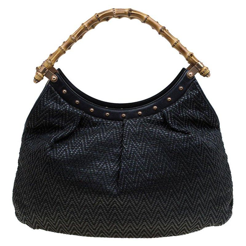 Introduced by the house of world’s leading luxury brands, Gucci, this hobo is versatile, stylish and highly utilitarian. Crafted in black woven leather, this bag comes with a dual bamboo top handle and decorated with golden studs. It opens to a