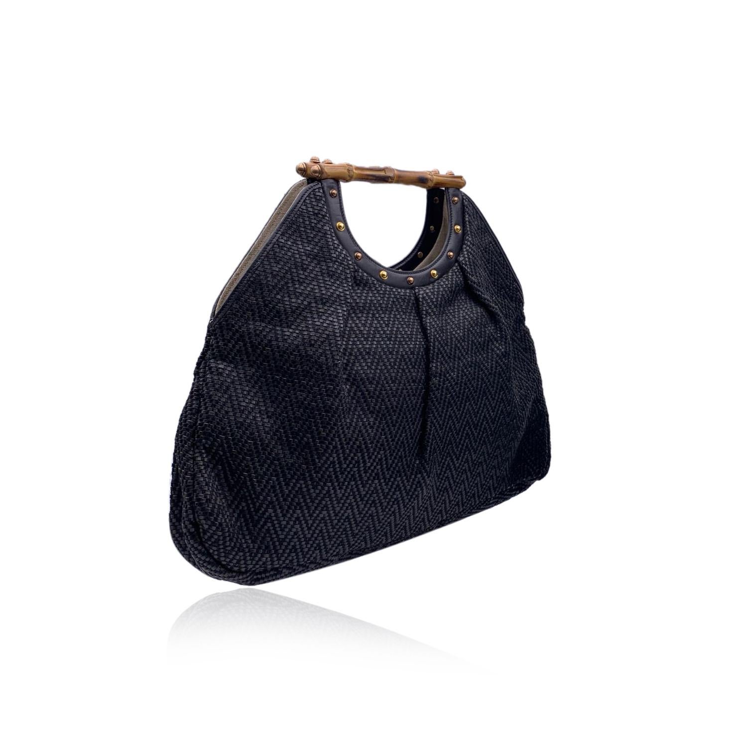 Beautiful Gucci Bamboo tote bag in black color. Crafted from woven leather and thread, with chevron pattern. Double distinctive Bamboo handle. Gold metal studs on the front and on the back. Open top. Beige fabric lining. 1 side zip pocket