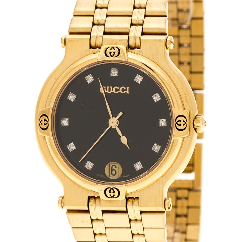 Keep time and accessorise your everyday style with this Gucci watch. It is made from gold-plated stainless steel and it has the GG logos on the bezel, and on the black dial, there are diamond hour markers and a date window. It is complete with a