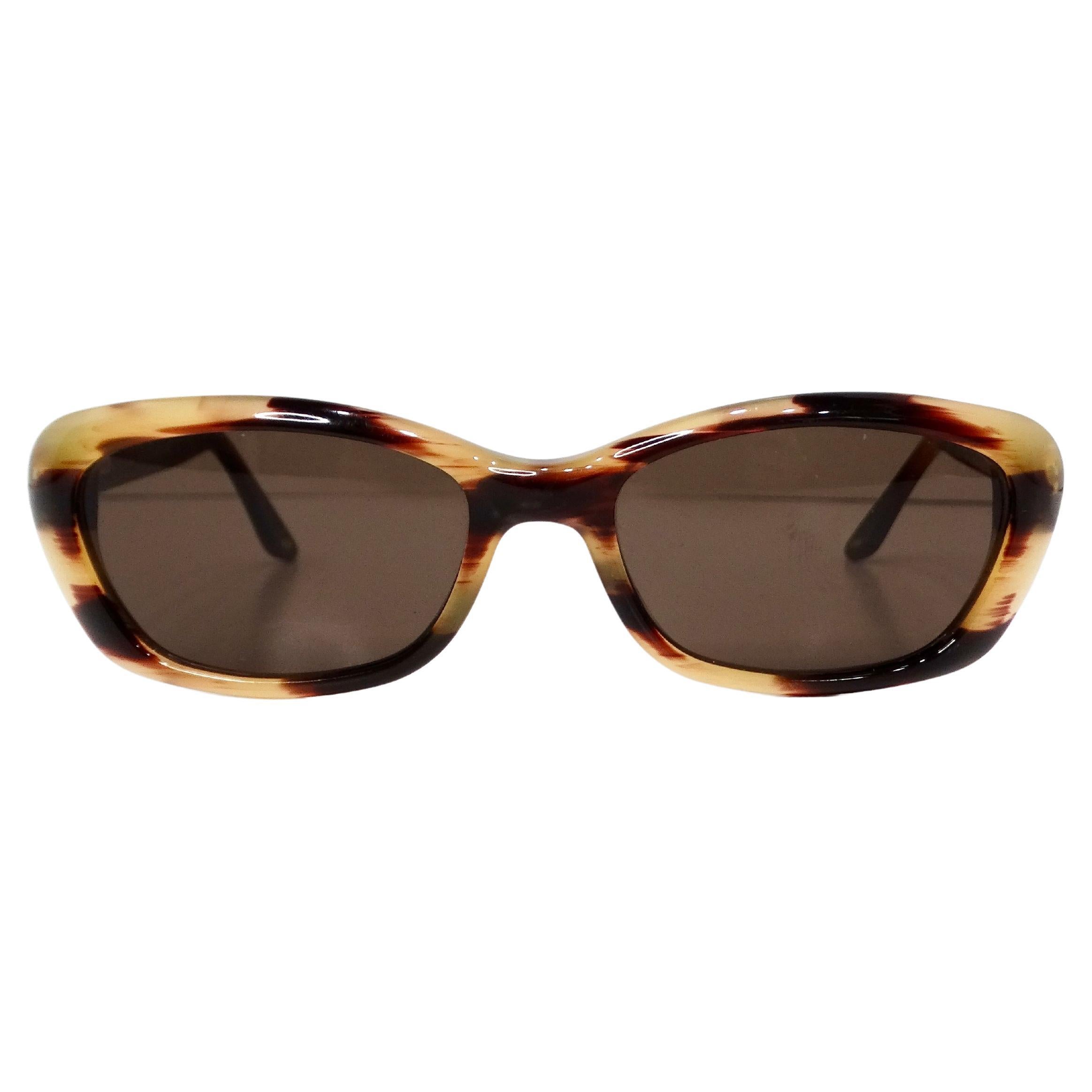 The Vintage Gucci Blonde Tortoise Cat Eye Tinted Sunglasses are the epitome of retro-chic sophistication. Crafted with a distinctive blonde tortoise shell frame, these sunglasses exude timeless elegance and effortless glamour. The cat eye shape adds