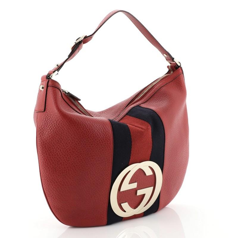 This Gucci Blondie Web Hobo Leather Large, crafted in red leather, features a large gold interlocking Gucci GG logo at its center, leather shoulder strap, signature Gucci Web stripes and gold-tone hardware. Its top zip closure opens to a black