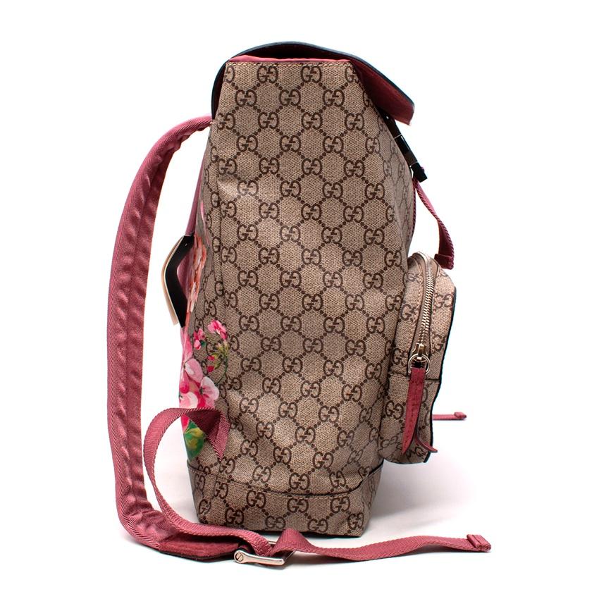 Gucci Blooms GG Monogram Canvas Backpack
 
 
 
 - Exterior in GG monogram canvas with pink and red floral designs. 
 
 - Main buckle closure, and zipped pockets
 
 - Silver hardware
 
 - Adjustable shoulder straps 
 
 - Interior plum suede
 
 
 
