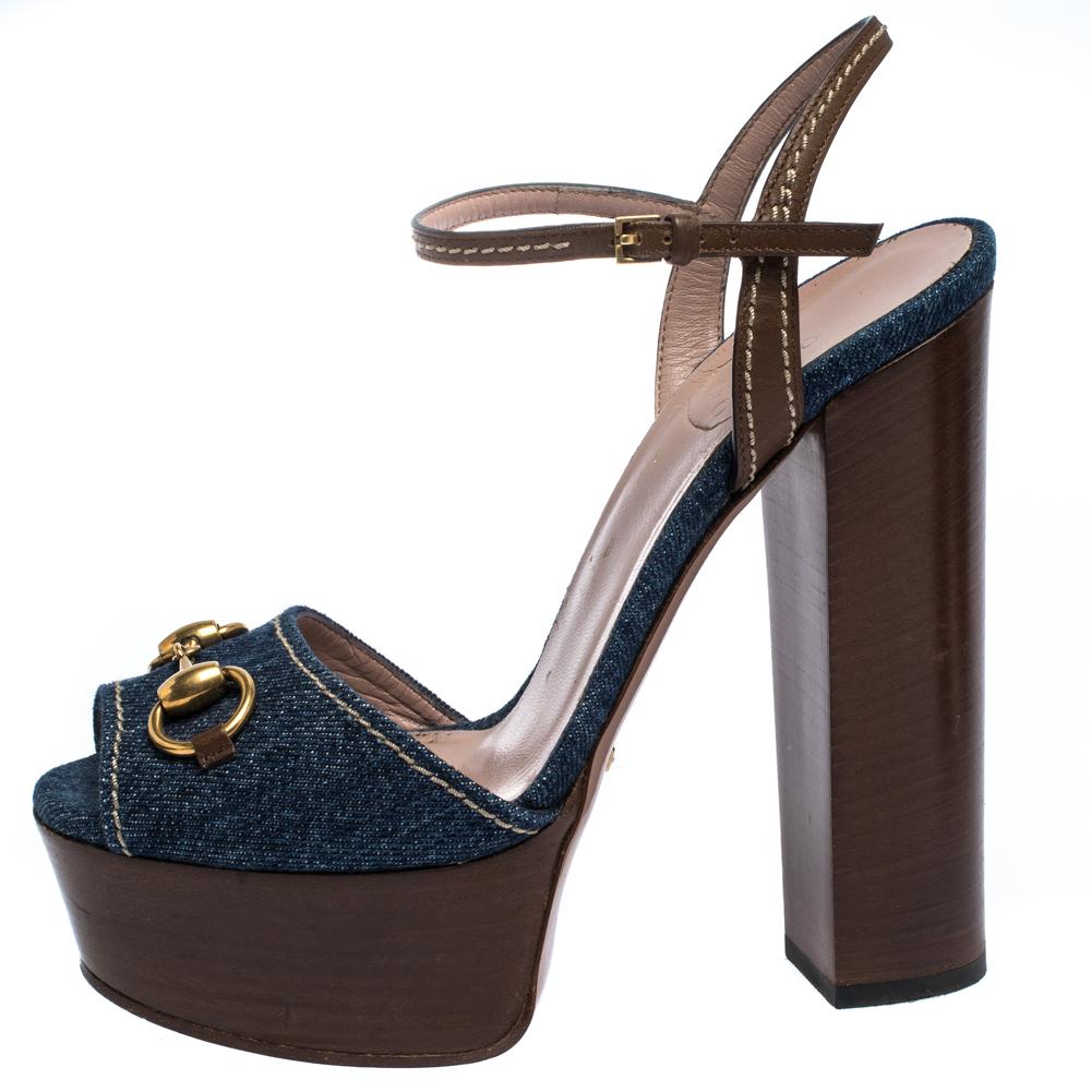 How lovely are these sandals from Gucci! They've been beautifully crafted from denim and leather and styled with Horsebit accents on the uppers. They carry open-toes, ankle straps and 15.5 cm block heels supported by platforms. Let this pair lift