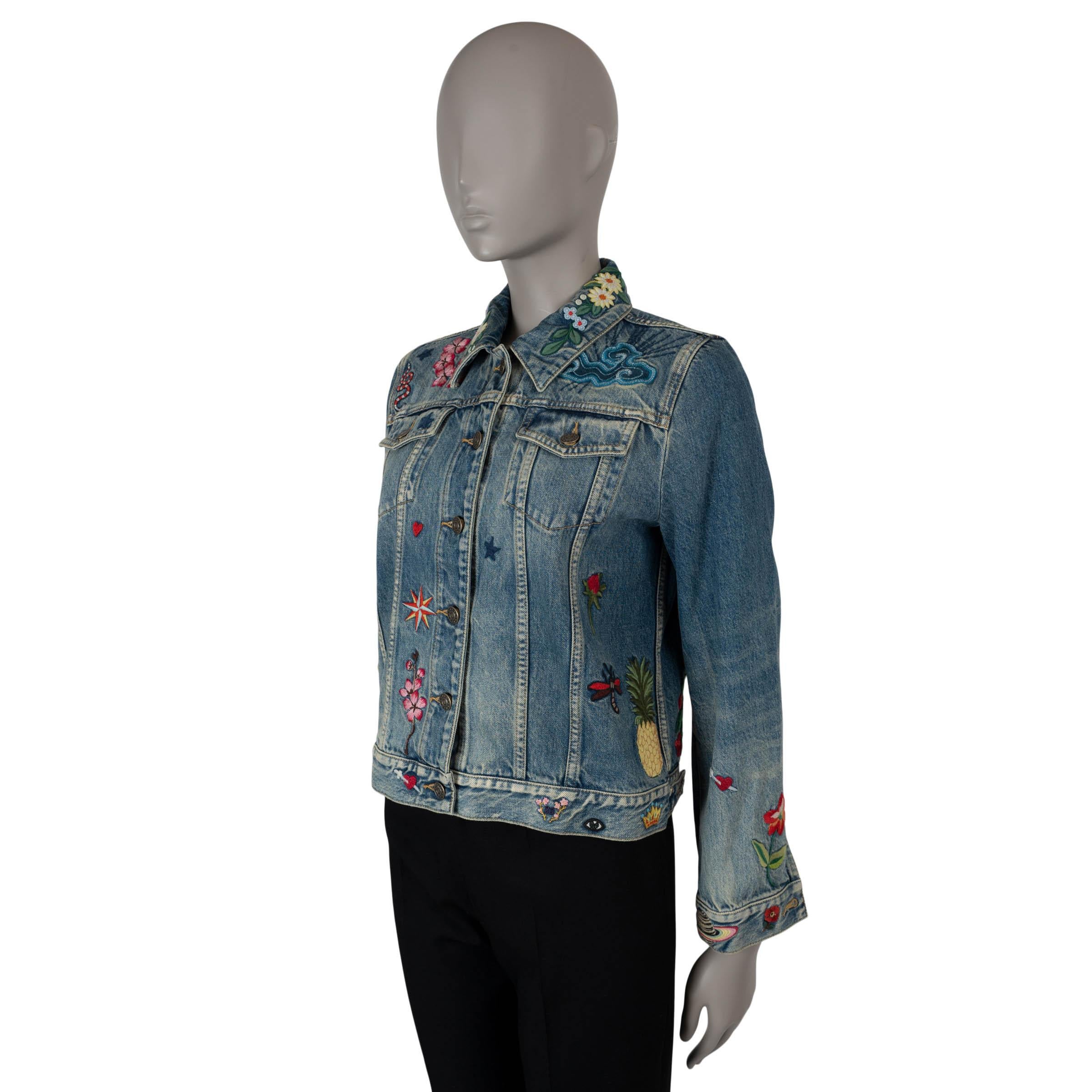This 100% authentic Gucci Blind for Love denim jacket in indigo blue cotton (100%) brings a playful twist to a classic design. Adorned with iconic Gucci motifs, including florals, planets, bees, and the signature snake, the jacket celebrates the